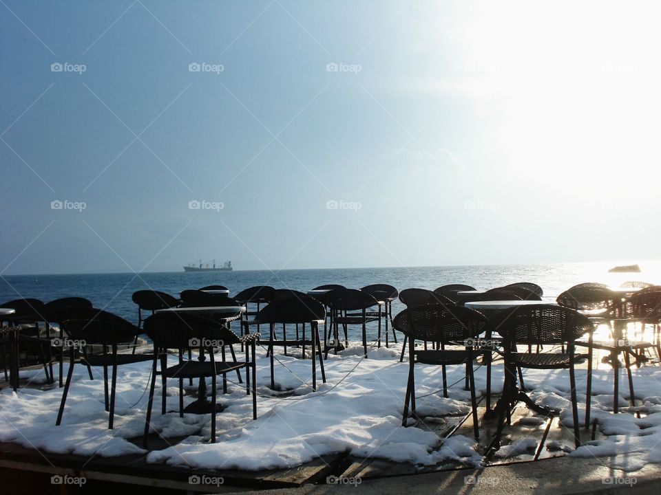 Snow, Chairs and the Sea