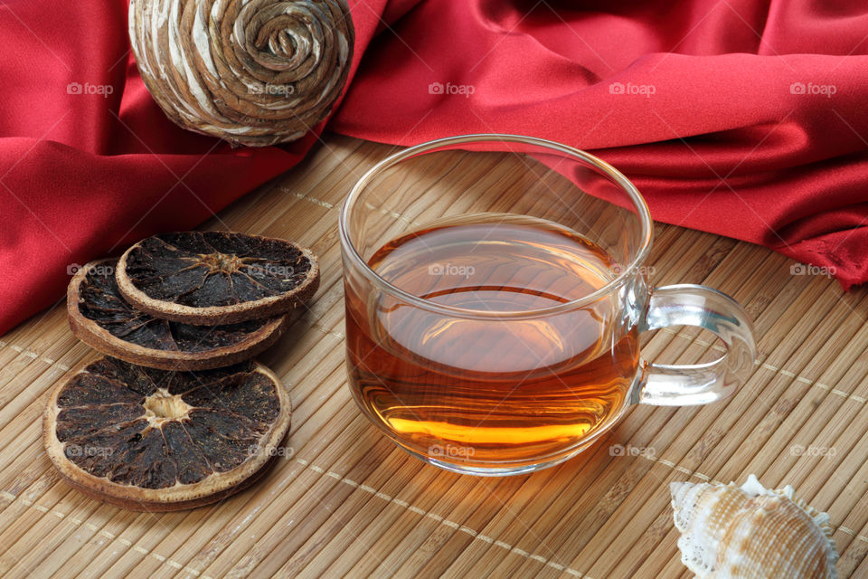 Tea cup with dried lemons and satin fabric