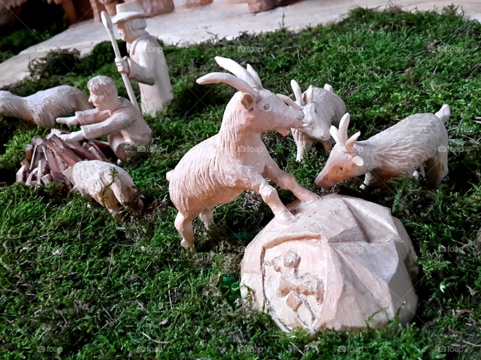 Christmas crib  scene with goats and Shepherd made from wood