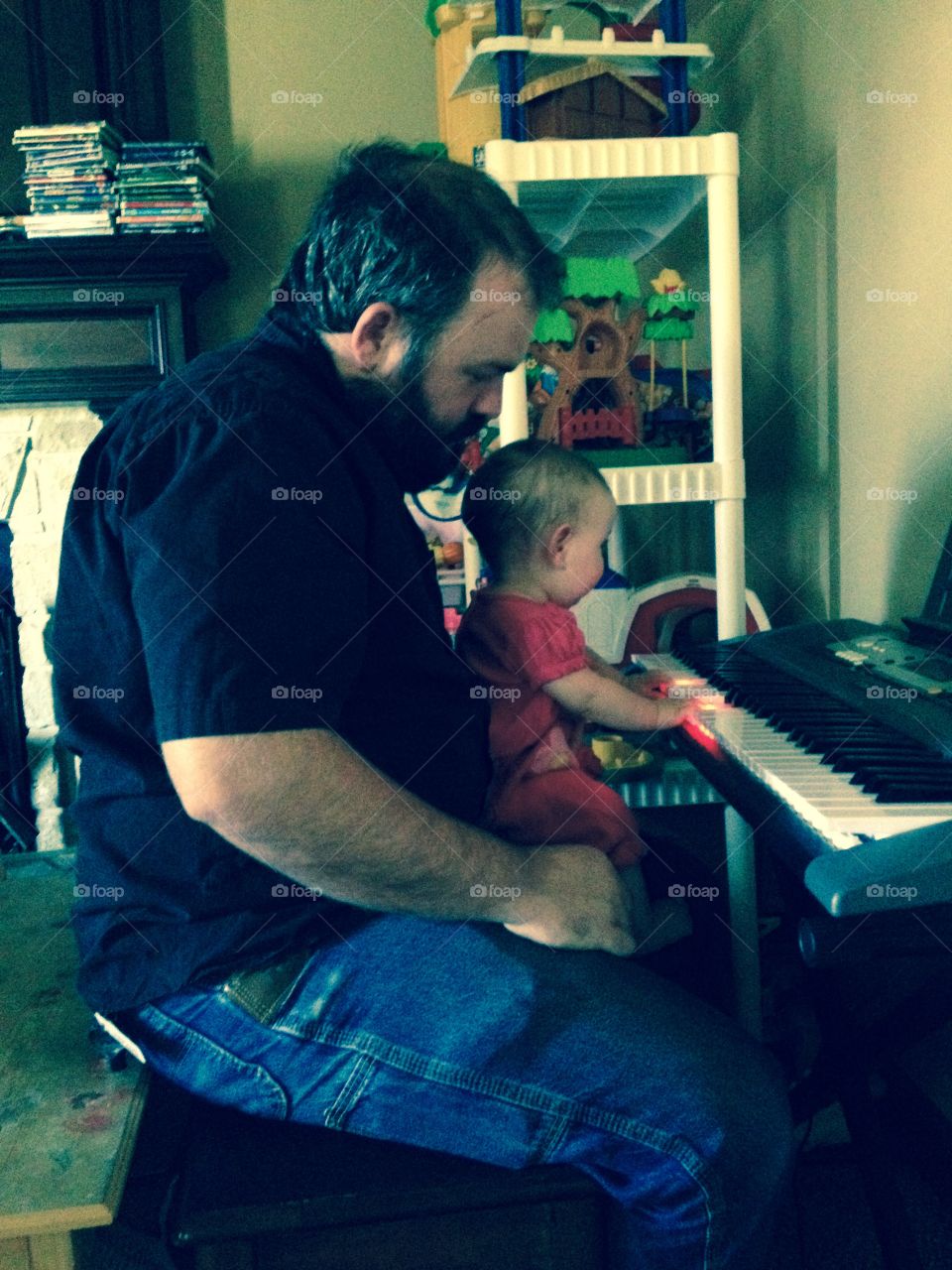 Piano lesson. Father at the piano with his daughter 