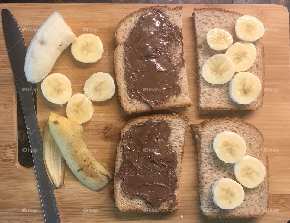 Lunch time with yummy Nutella and banana sandwiches displayed on a cutting board. USA, America 