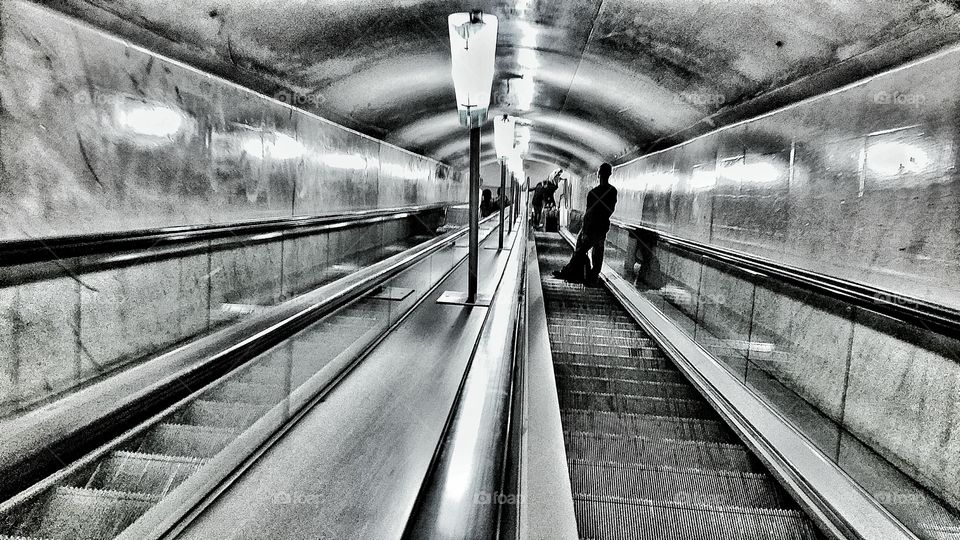 Going down. going underground in a parisian metro.
