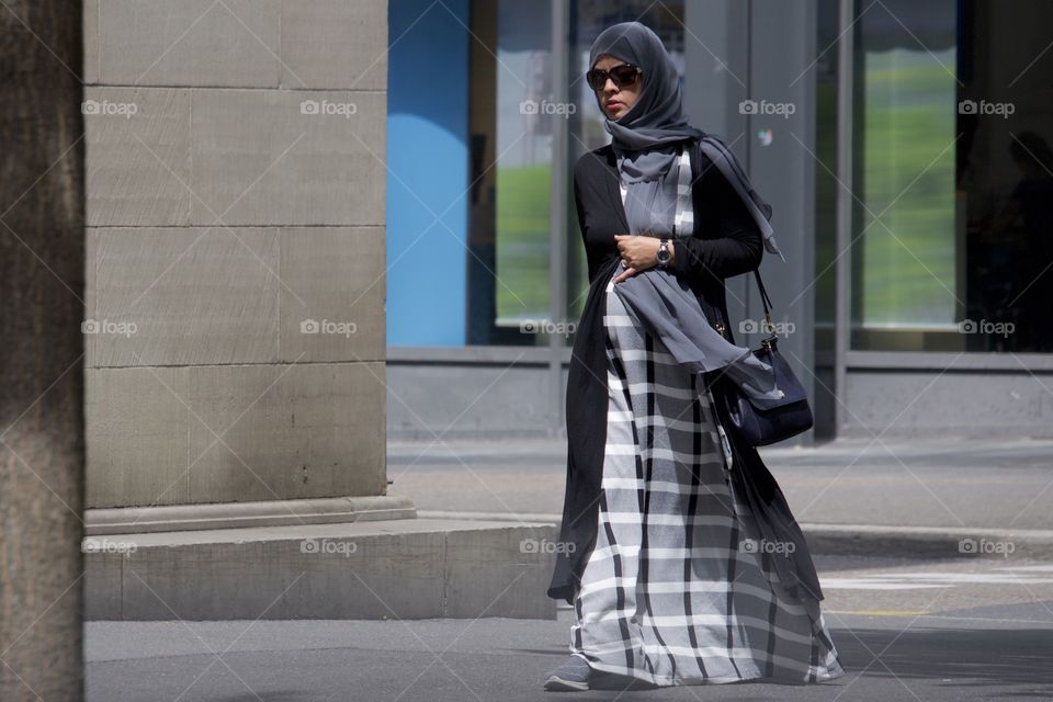 Street Photography.Muslim woman wearing grey scarf.