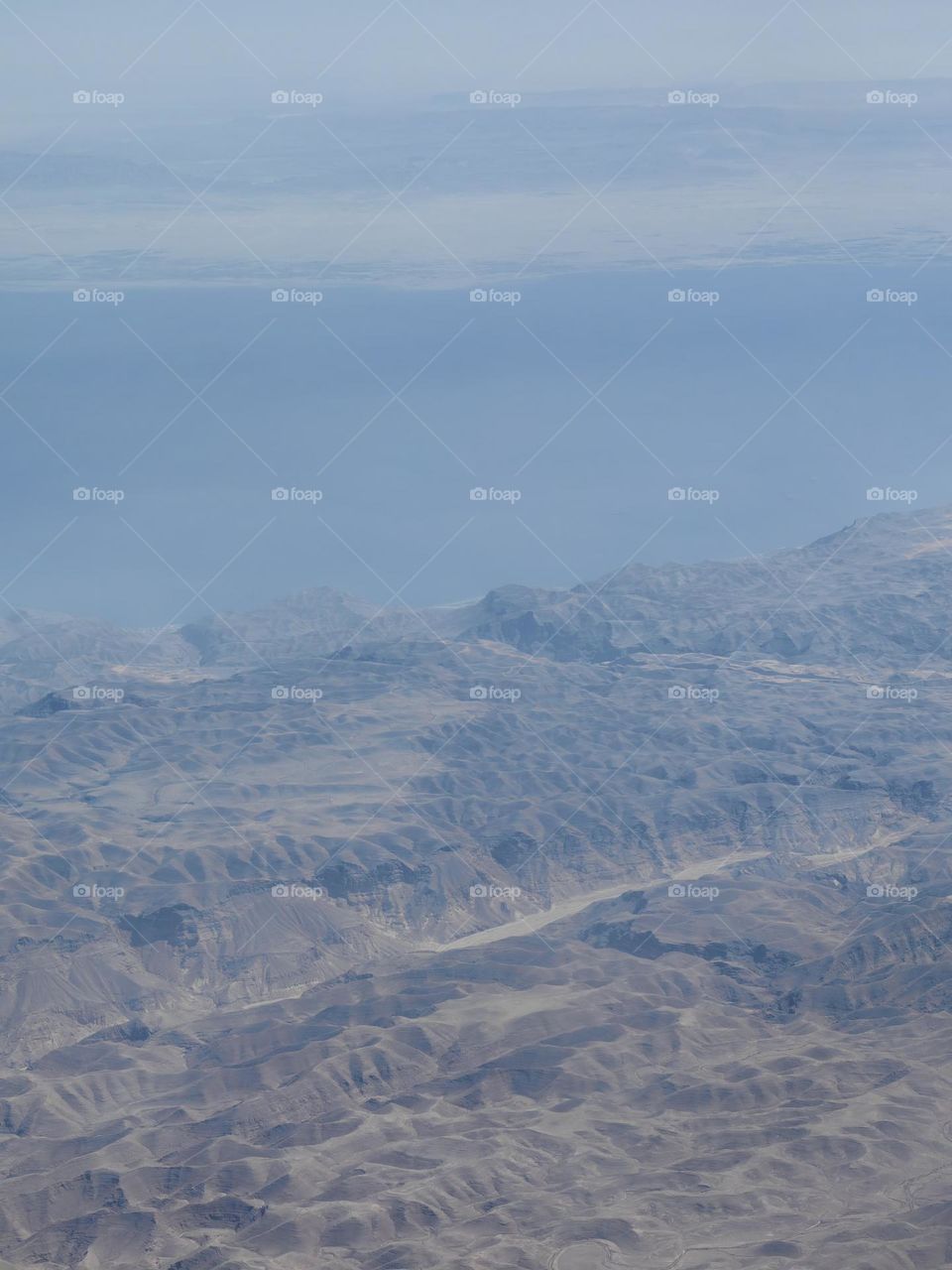 Sea and mountains from the window of the plane