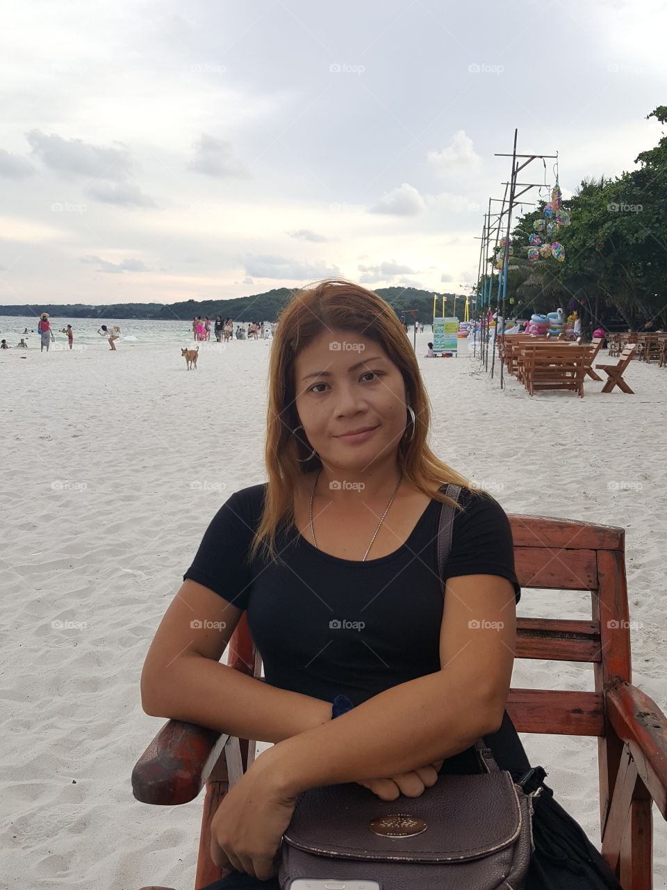 Thai woman waiting for a restaurant on Koh Samet beach