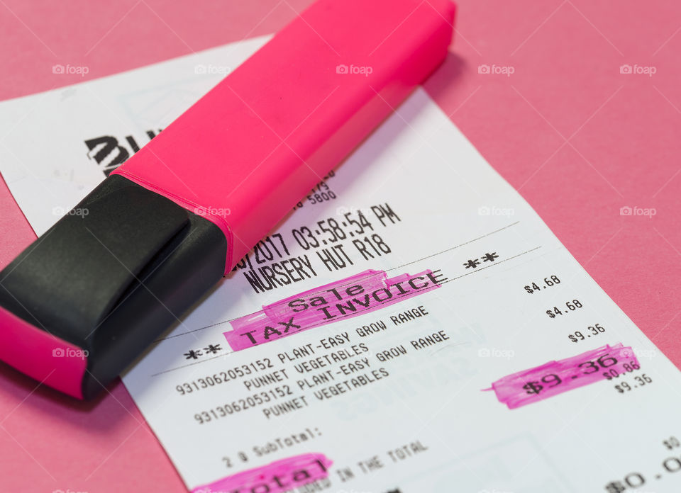 Highlighted items on tax docket and pink highlighter pen.