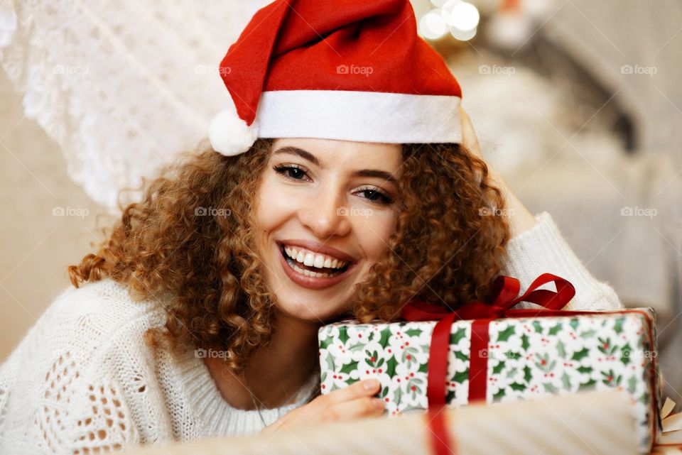 Smiling female holding Christmas gift