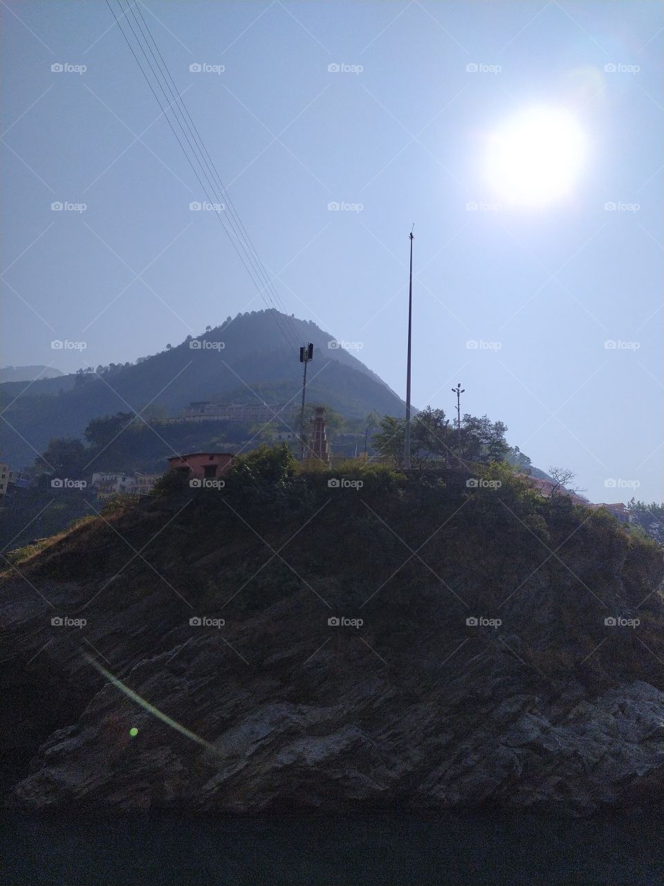 View of clock tower and mountains on the bank of holy Alaknanda