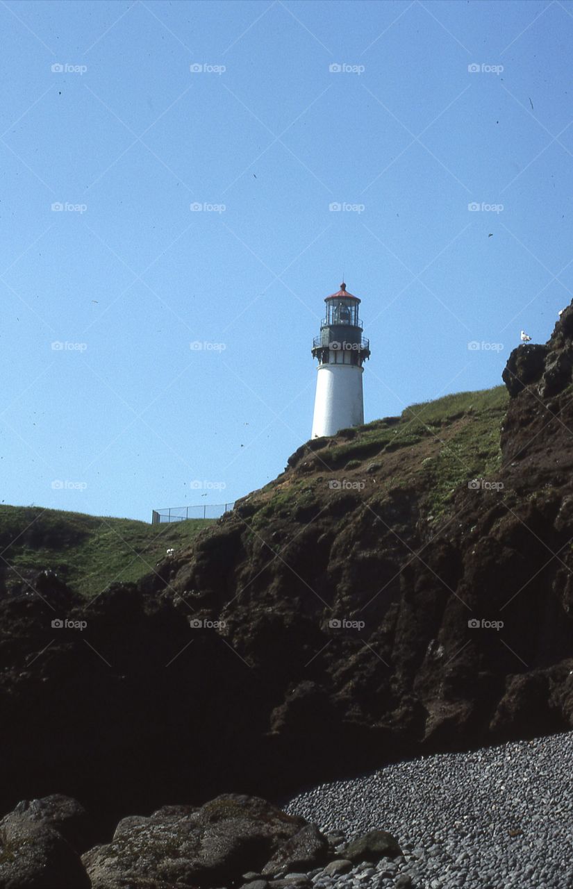 lighthouse rocks Blue Sky gravel coastline