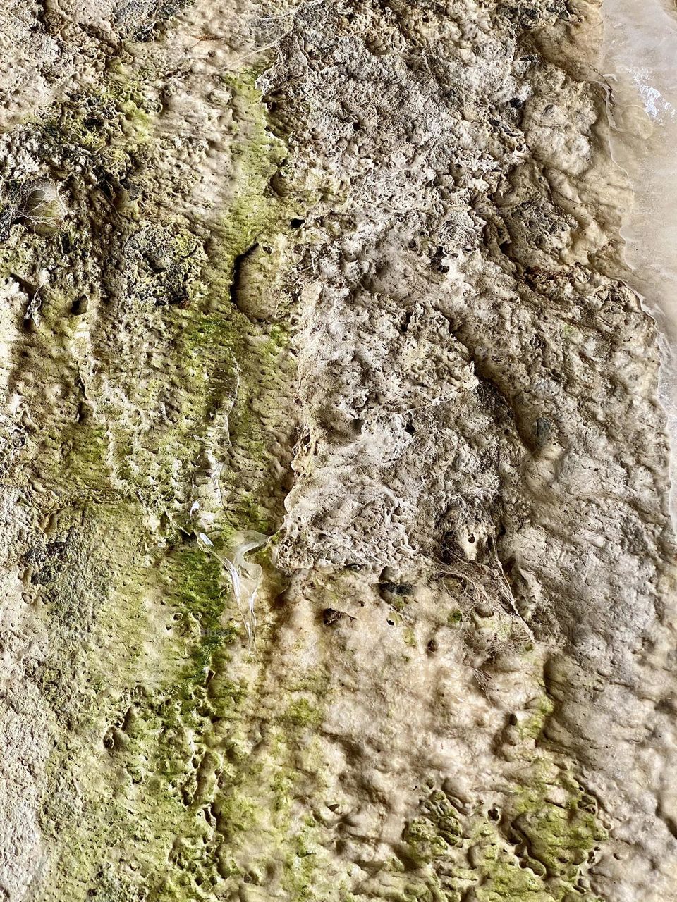 Mineral deposits and ice on the wall of a tunnel