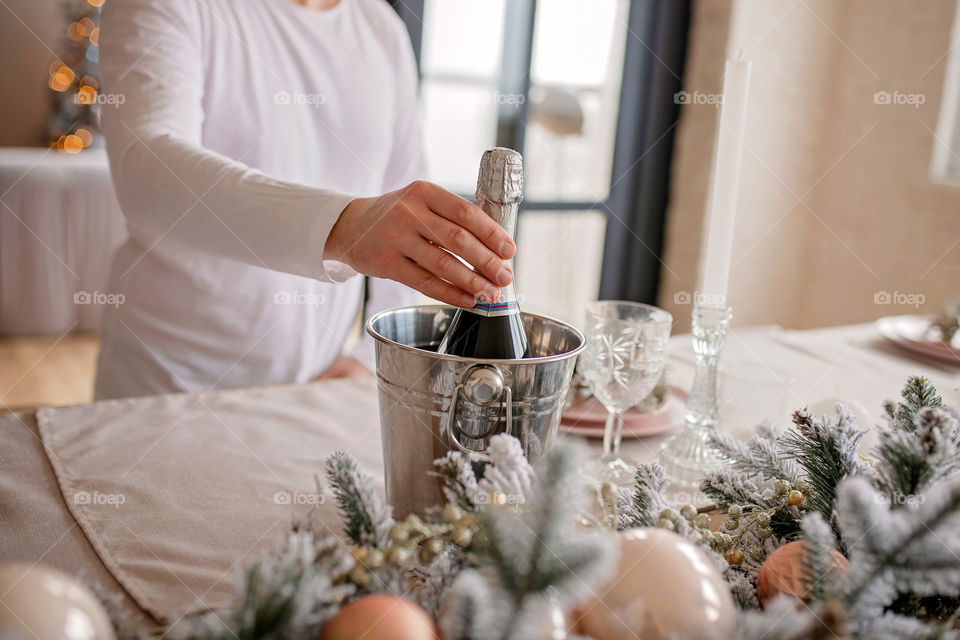 man sets a beautiful decorated winter table for a festive dinner.  Merry Christmas and Happy New Year.