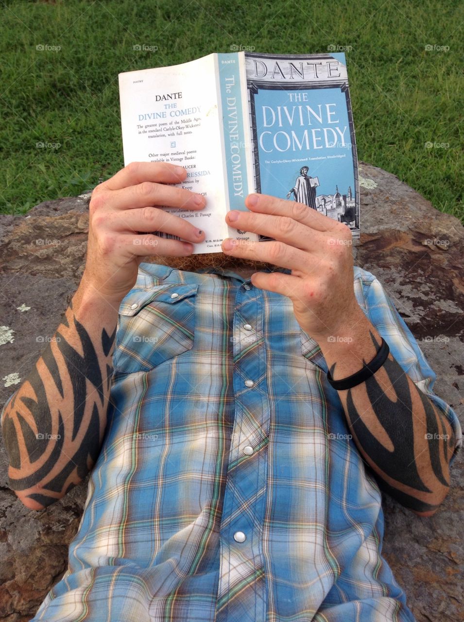 Man with tattoos reading "A Divine Comedy."