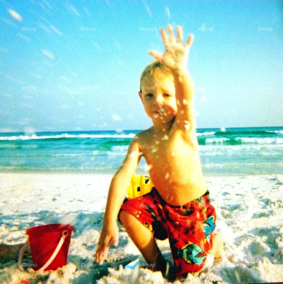 Throwing beach sand