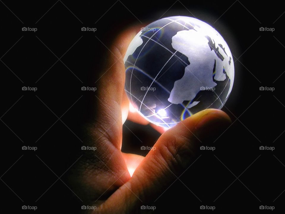 The World in My Hand.

Glass globe in hand, illuminated from below, rainbows visible. 