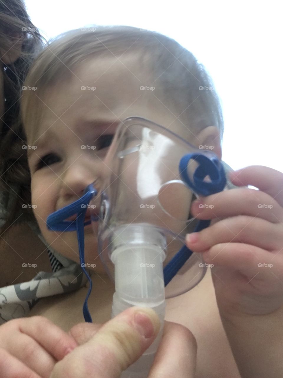 Close-up of cute baby boy wearing oxygen mask