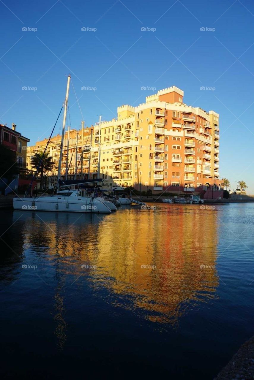 Building#sea#sun#reflect#boats