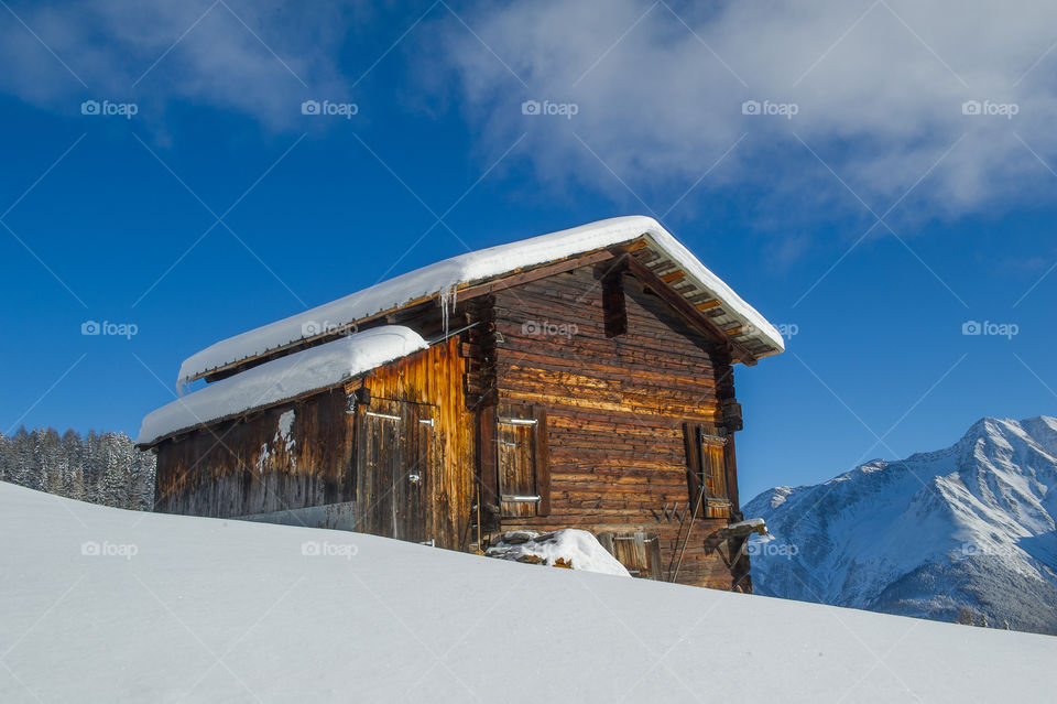 old wooden cottage in a winter landscape 