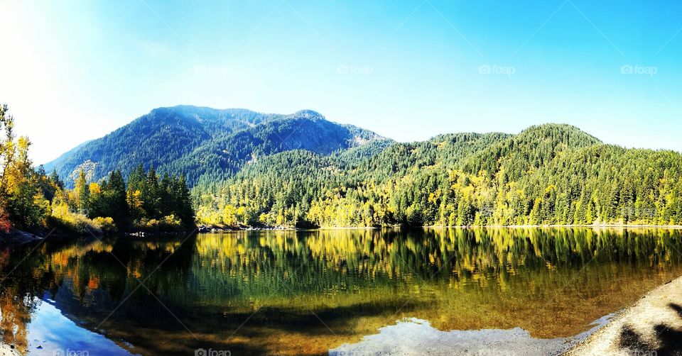 View of reflected hill on water