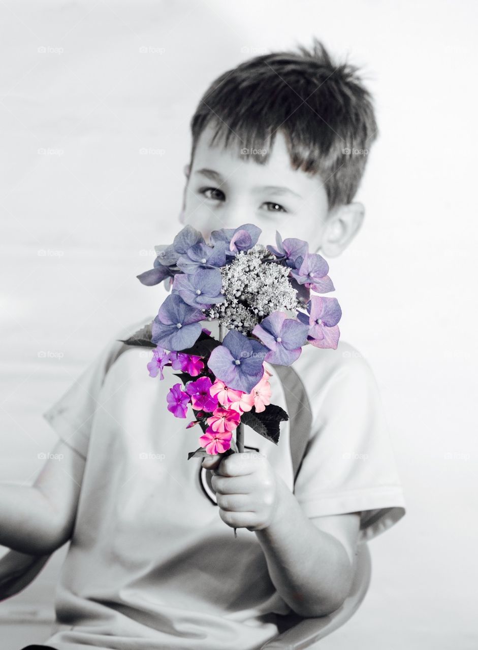 Little boy gives present Flowers mothersday