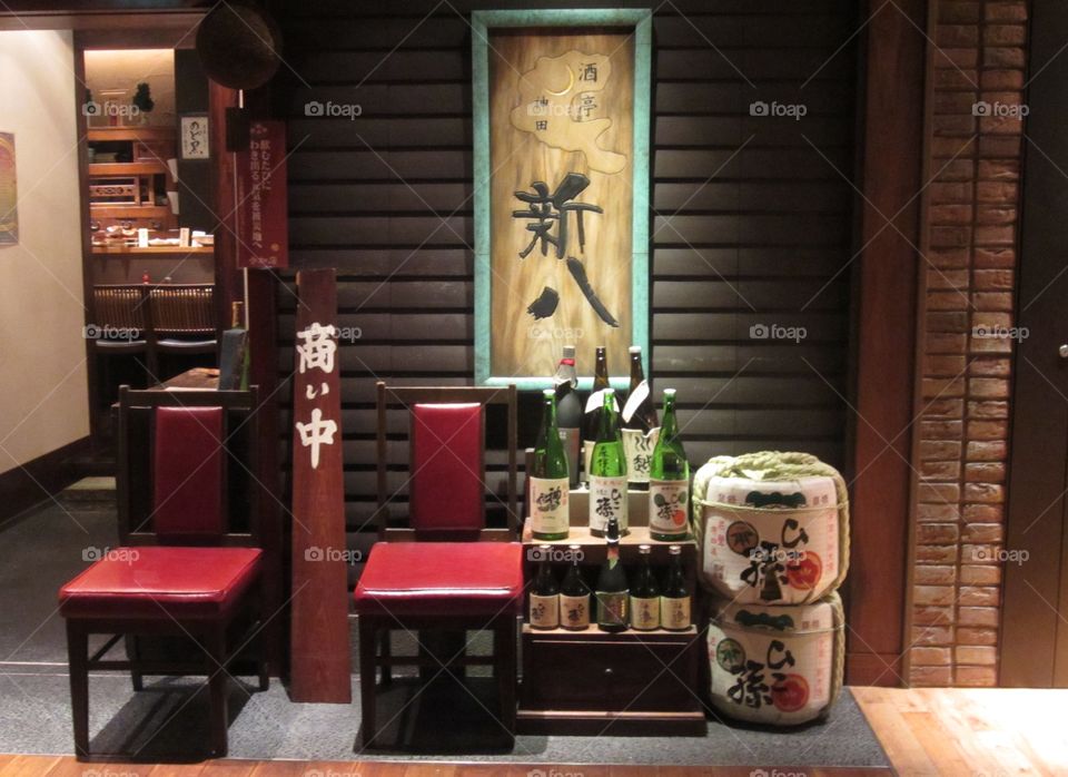 Traditional Japanese Sake Display, Tokyo Station.  Green Glass Bottles