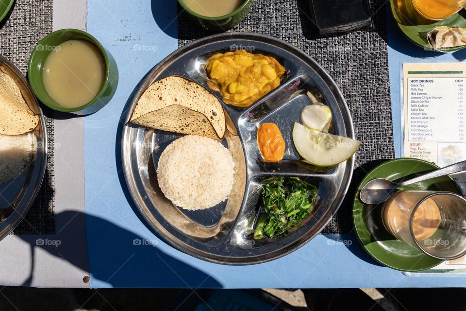 Traditional nepalese food called Dal Bhat, prepared with rice, different vegetables, sometimes meat and le til soup.