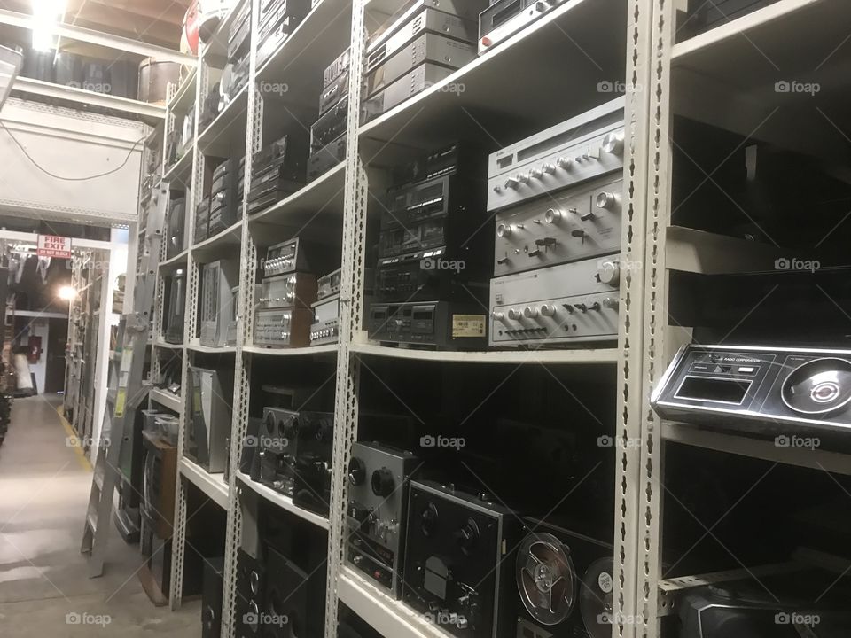 Shelves packed with old electronics from floor to ceiling 