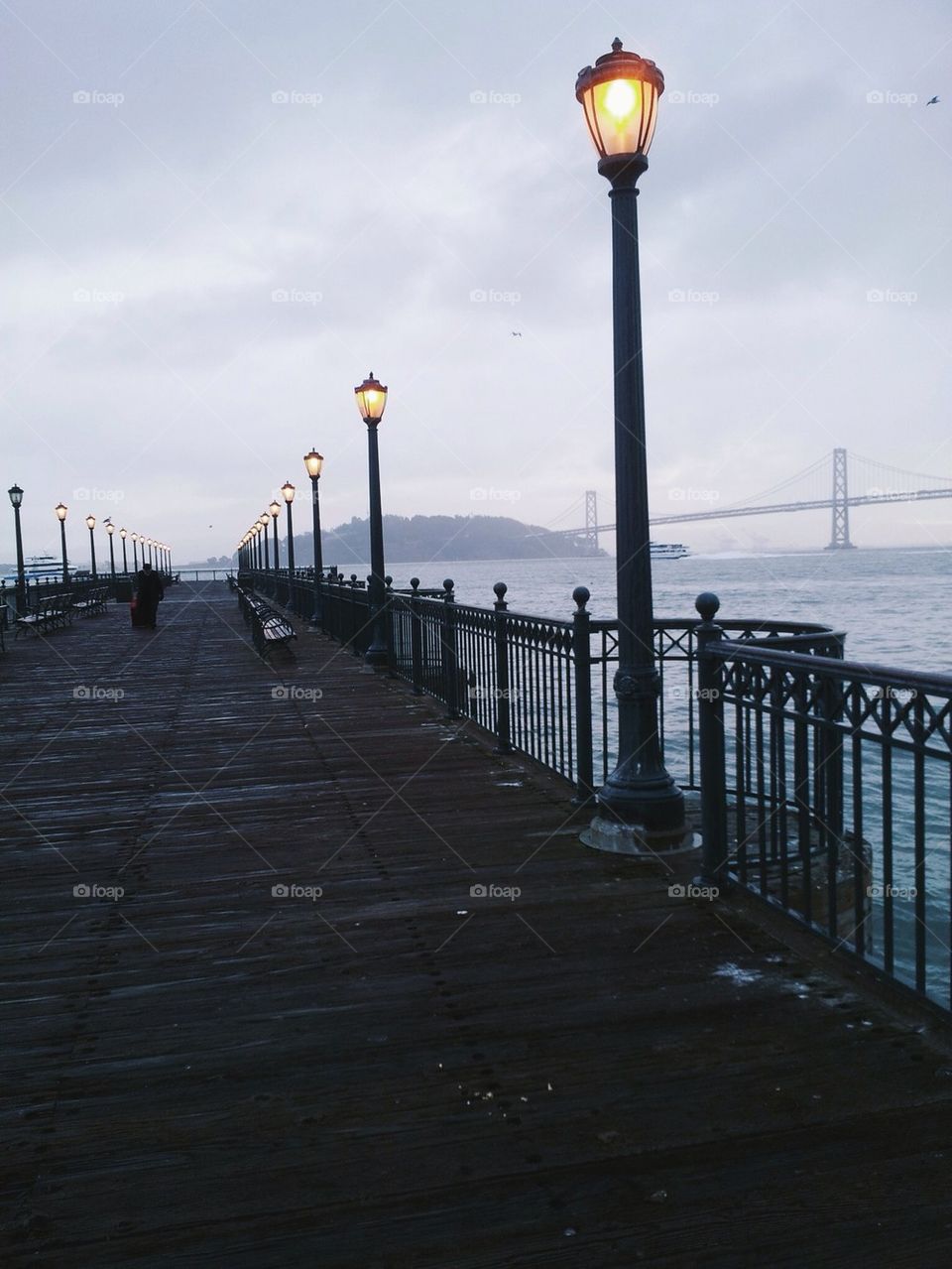 Lone Man Walking on Pier