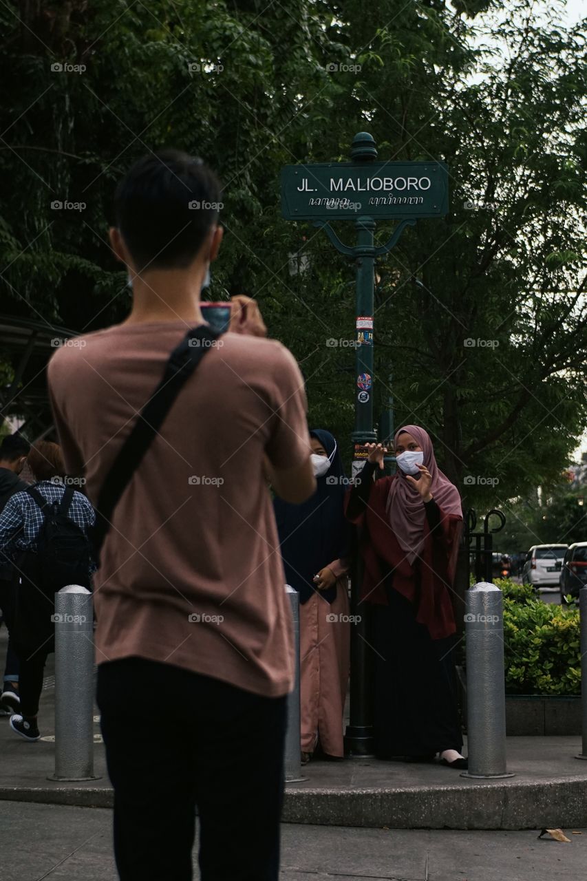 A woman wearing a hijab is posing when being photographed