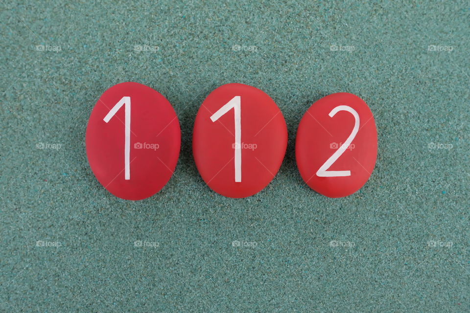 Stones design of 112,  phone number for free emergency telephone number in 28 European Union countries over green sand