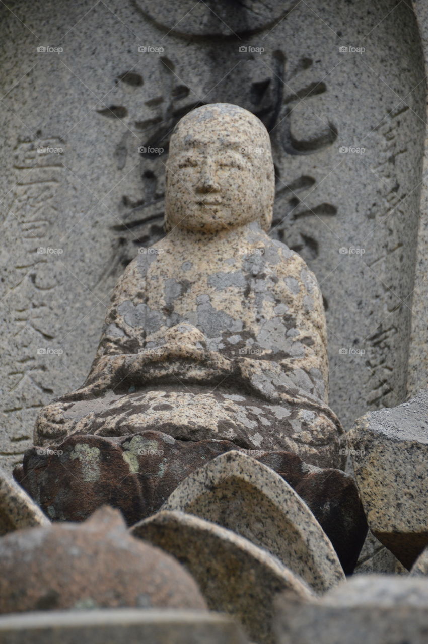 Japanese Buddha Statue At A Grave
