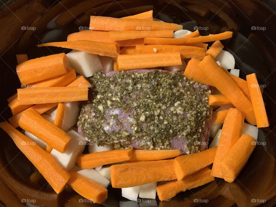 Garlic and basil pesto pork roast with potatoes and carrots 
