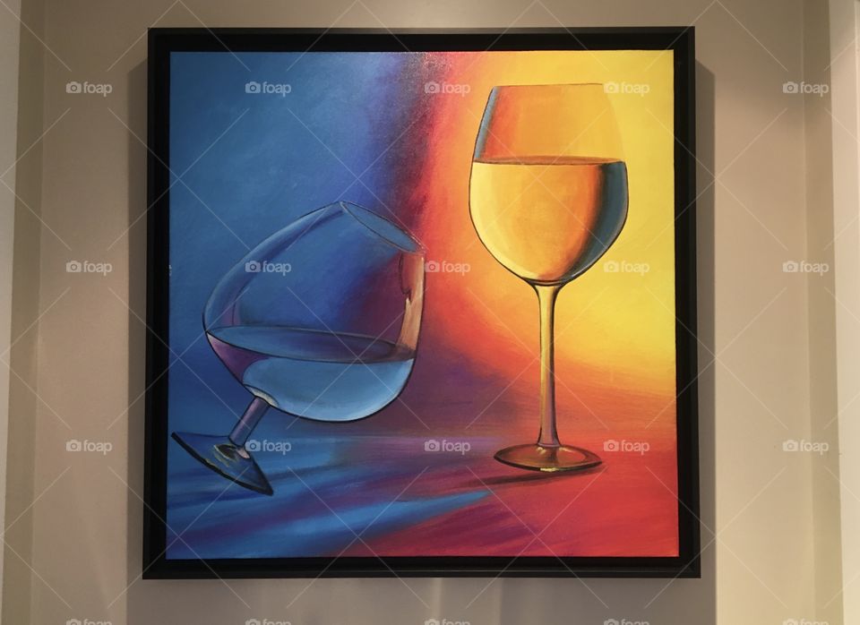 Blue and orange glasses on a painting 
