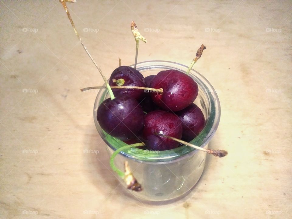 Cup full of cherries.