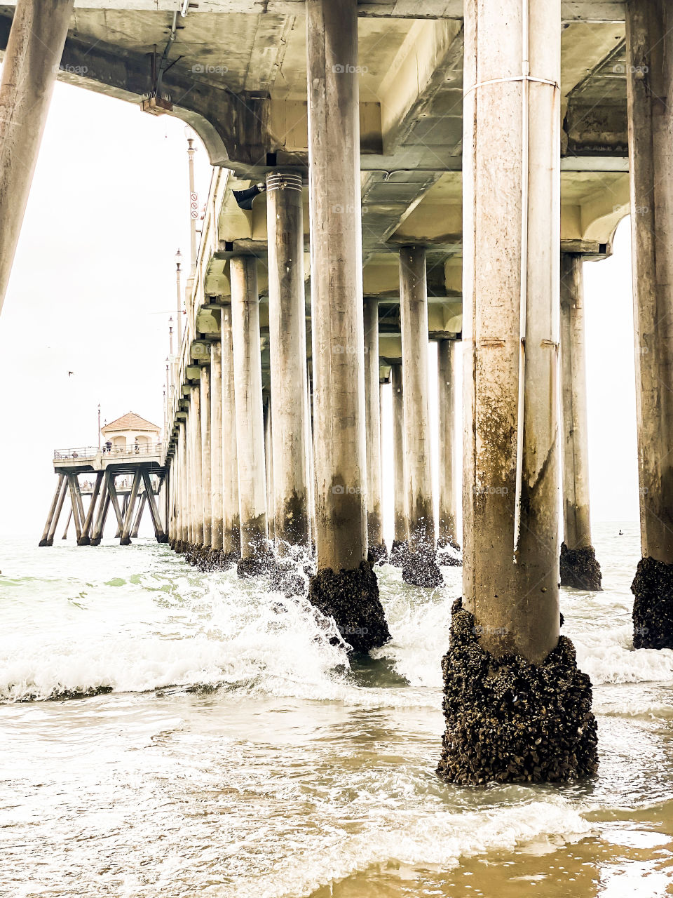 Beach pier in Huntington Beach California is truly a magically site to see. How these large pillars stand up tall in the ocean is mesmerizing! 