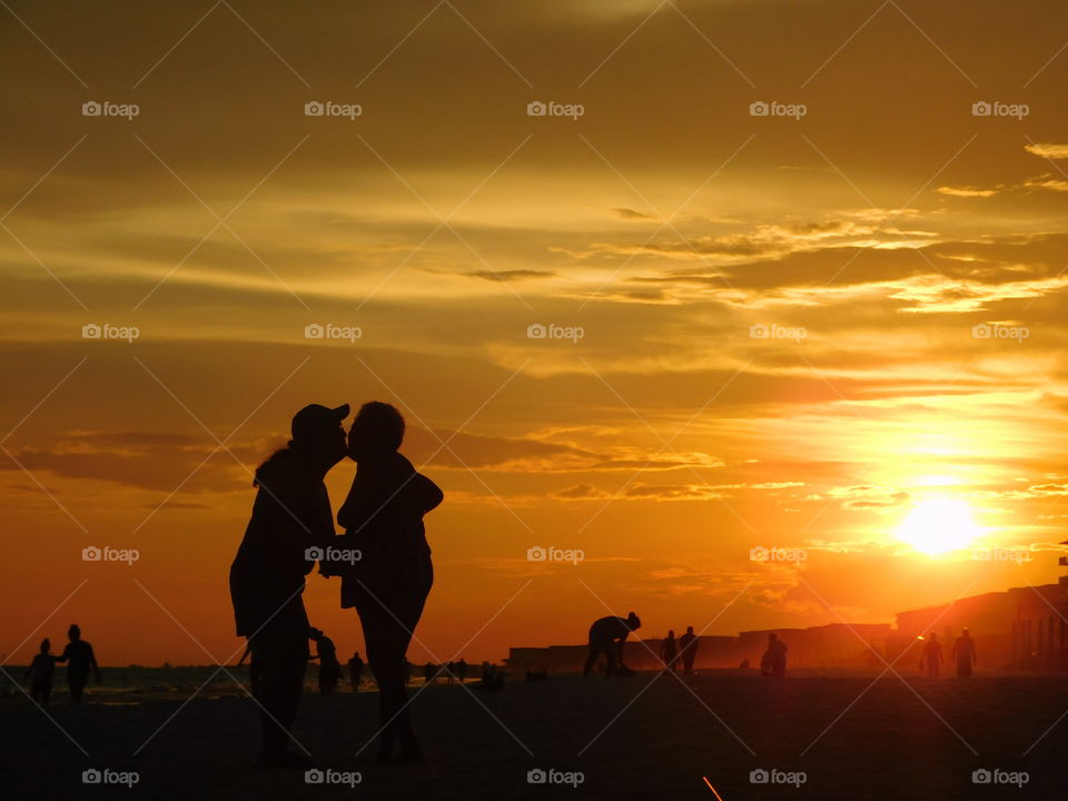 Silhouette of couple kissing on beach