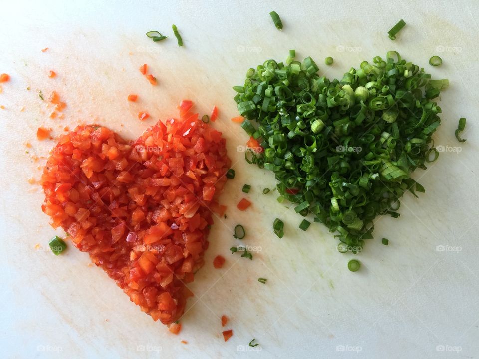 Healthy for your heart. Chopped red bell pepper and green onion in cutting board