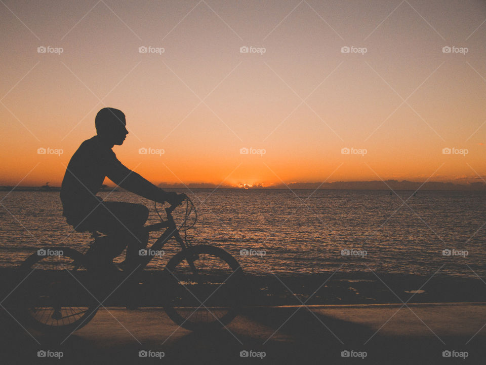 Biking by the boardwalk contemplating the sunrise 
