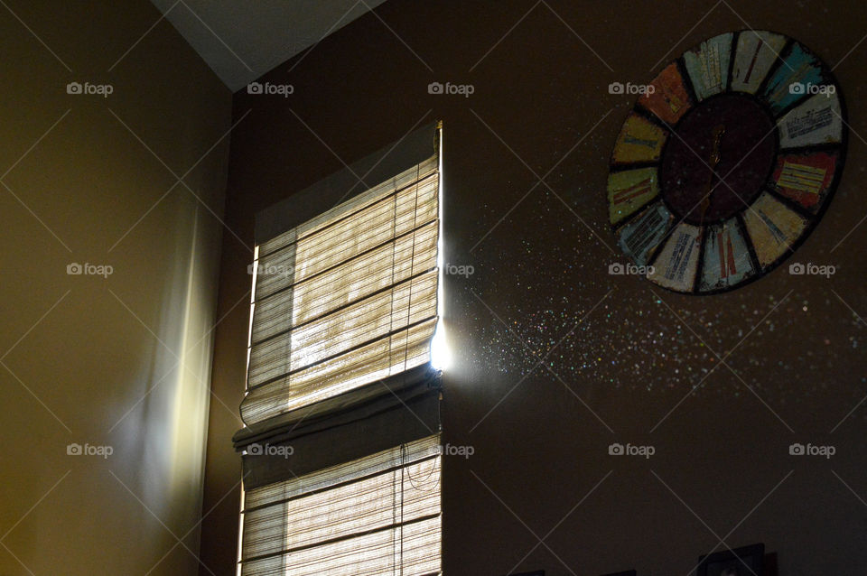 Sunlight peering through a window, causing dust particles to glitter and glow
