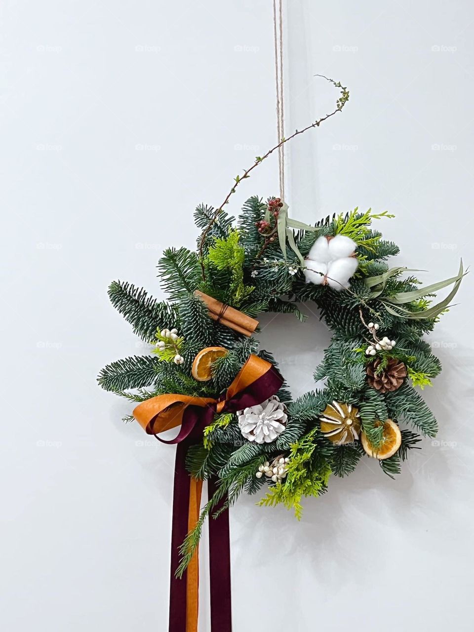 As simple as a wreath hanging on the plain white wall