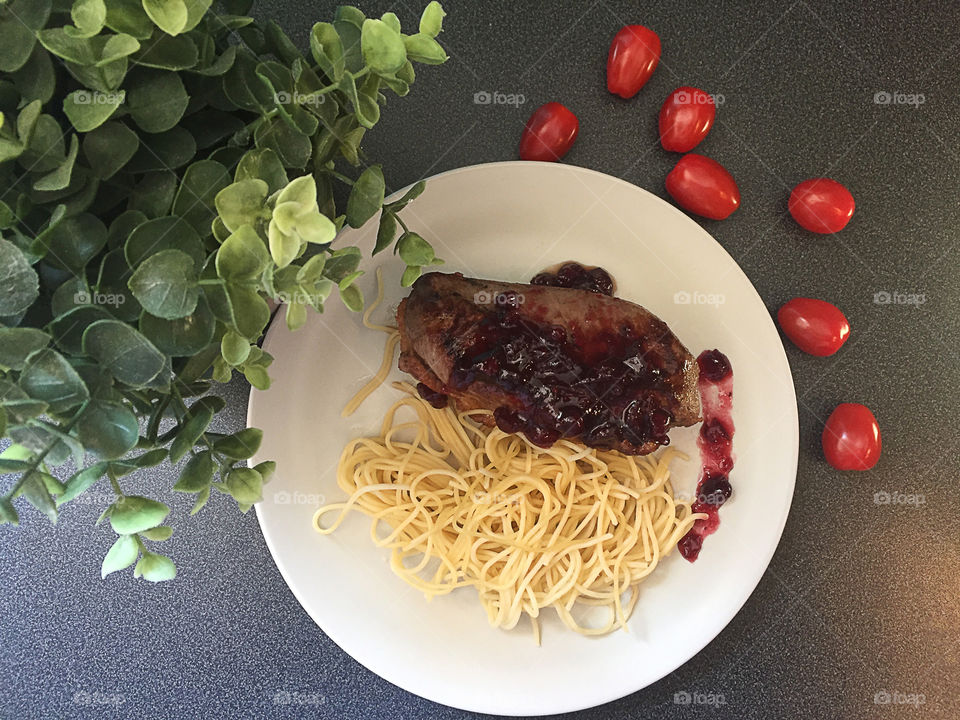 Food flatlay. Duck fillet with spaghetti and tomatoes cherry