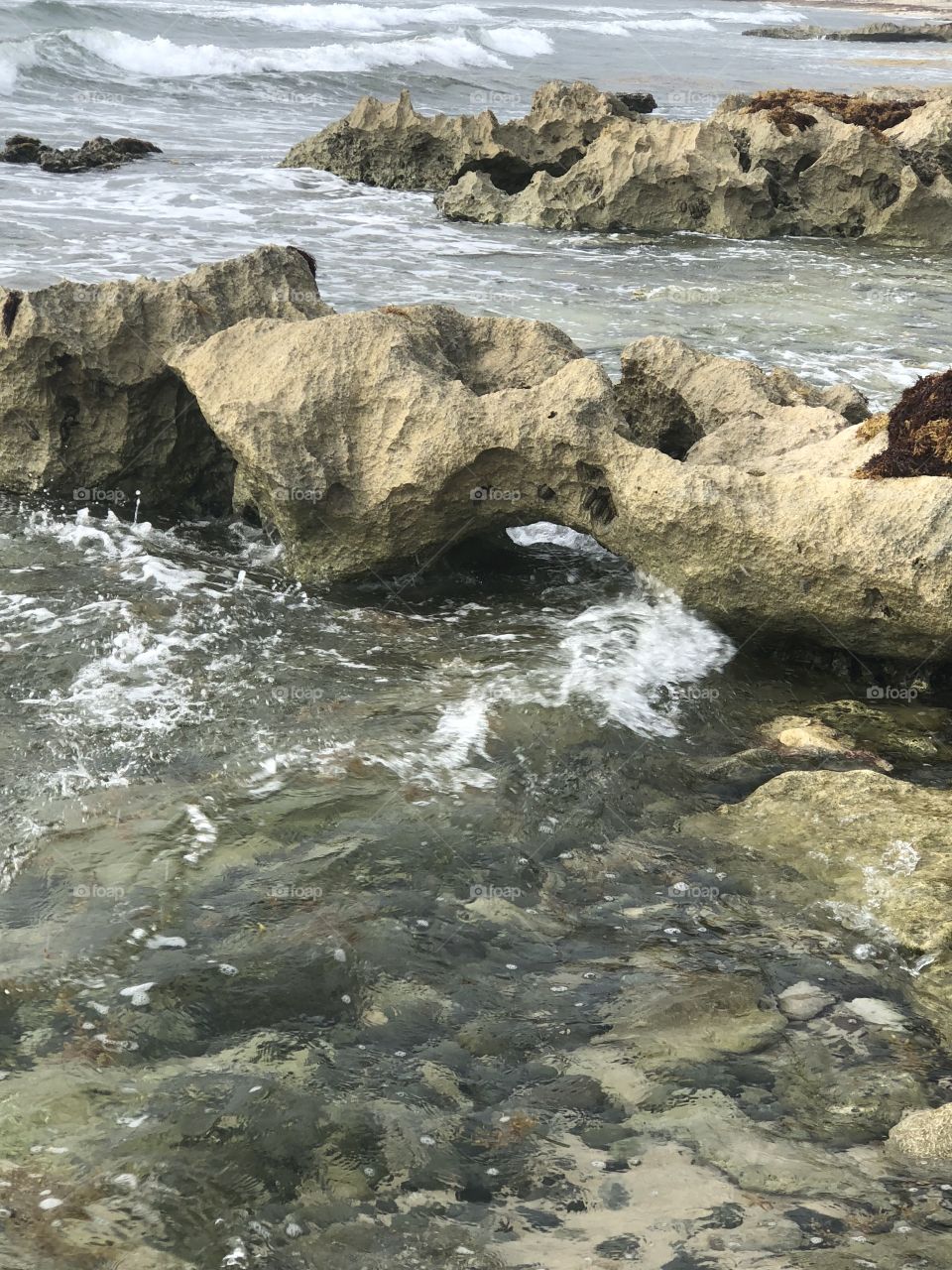 Waves crashing through rocks at beach