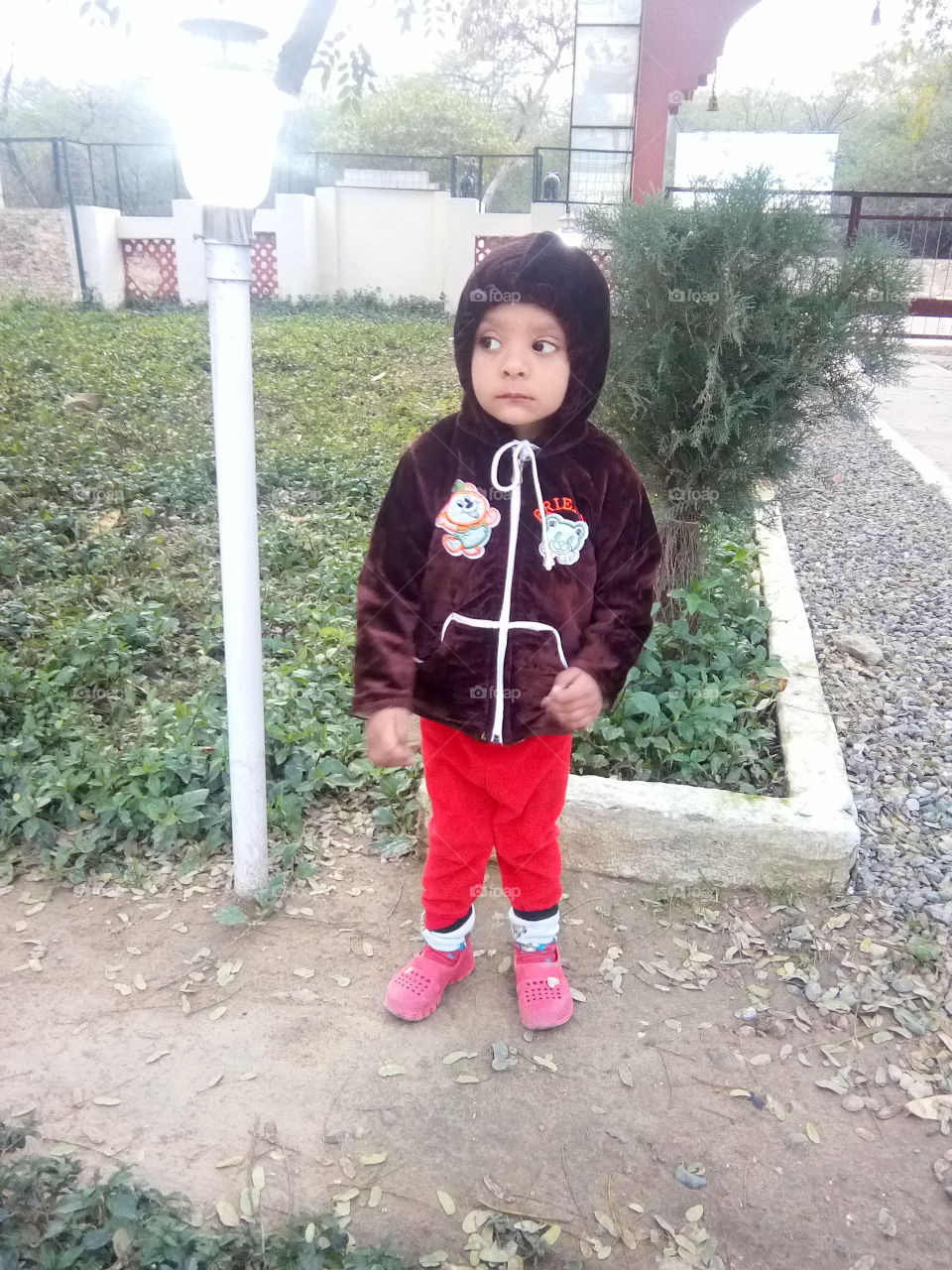 a cute little boy in a park.