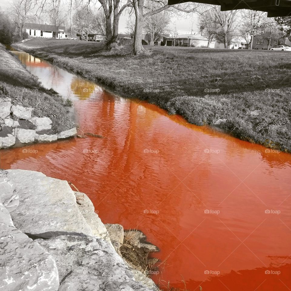 polluted stream running red