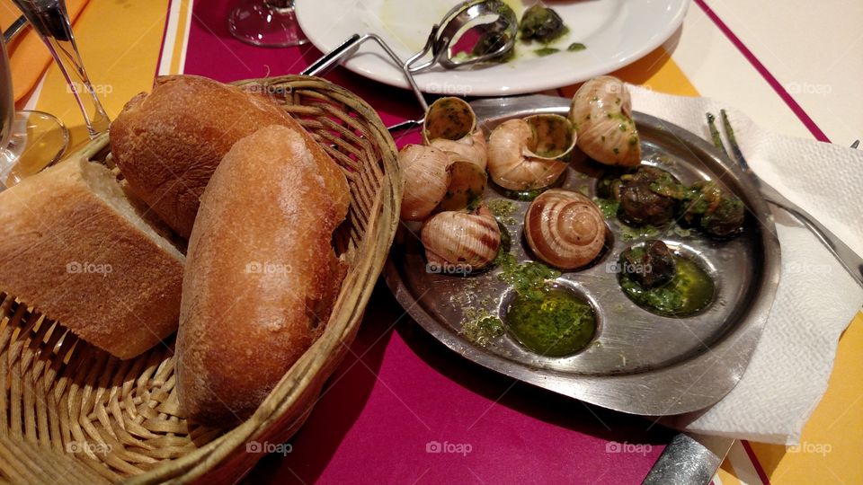Delicious escargots with crusty French bread in Paris.