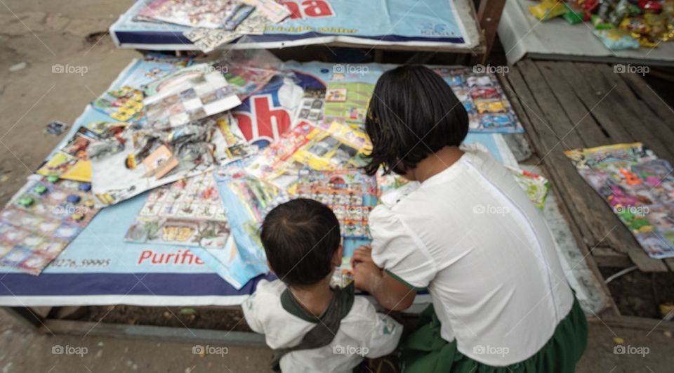 Colorful local life , Student are choosing toy at U bien , the longest wooden bridge in Mandalay Myanmar