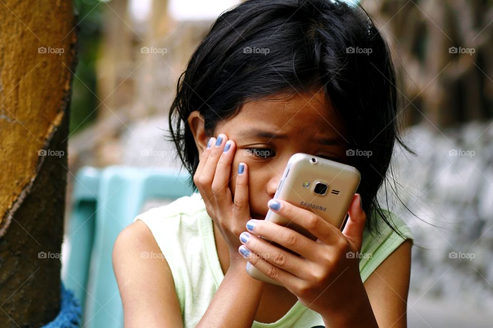 young girl watching a video on a smartphone