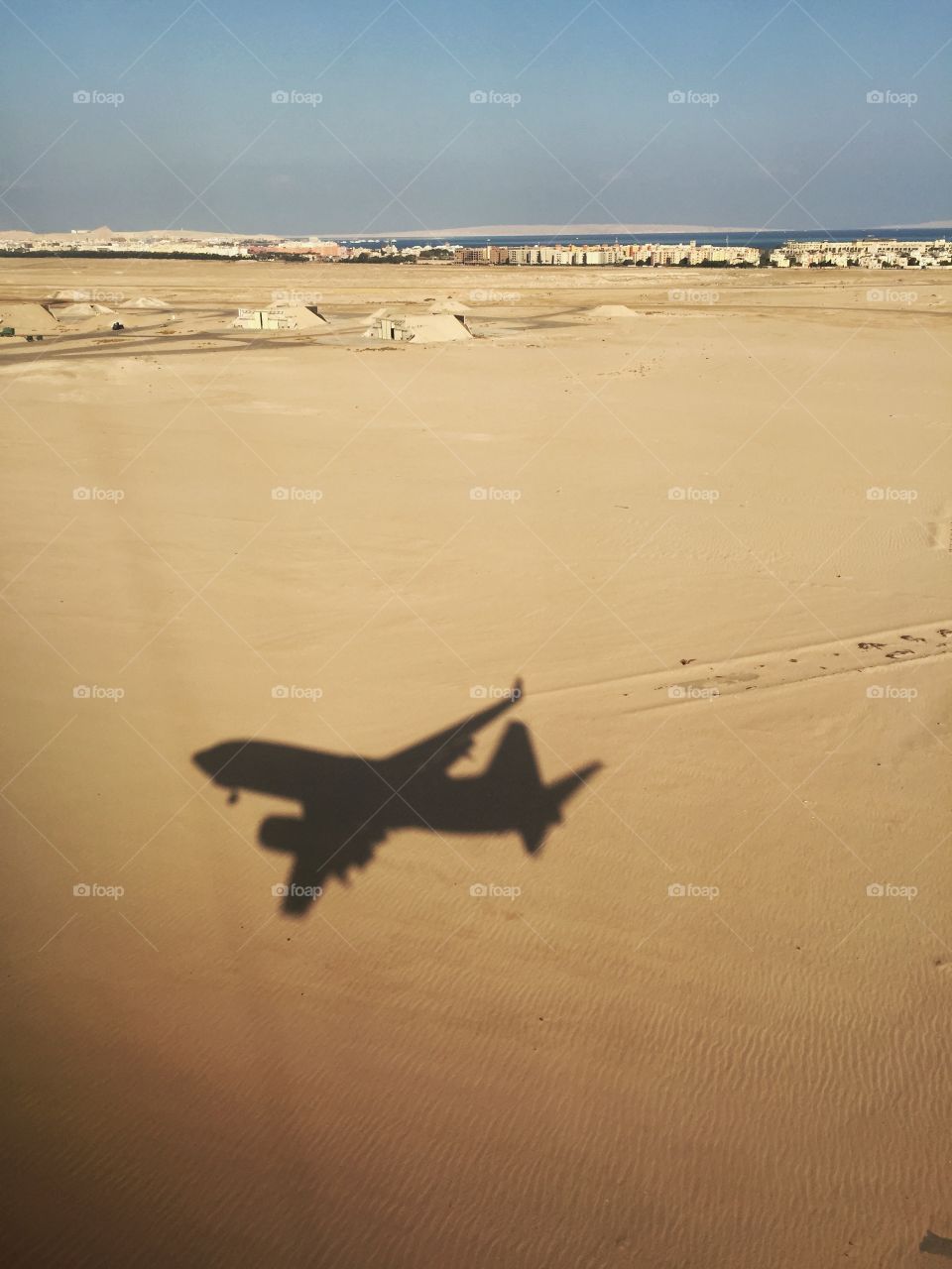 Shadow of flying airplane on the Sand