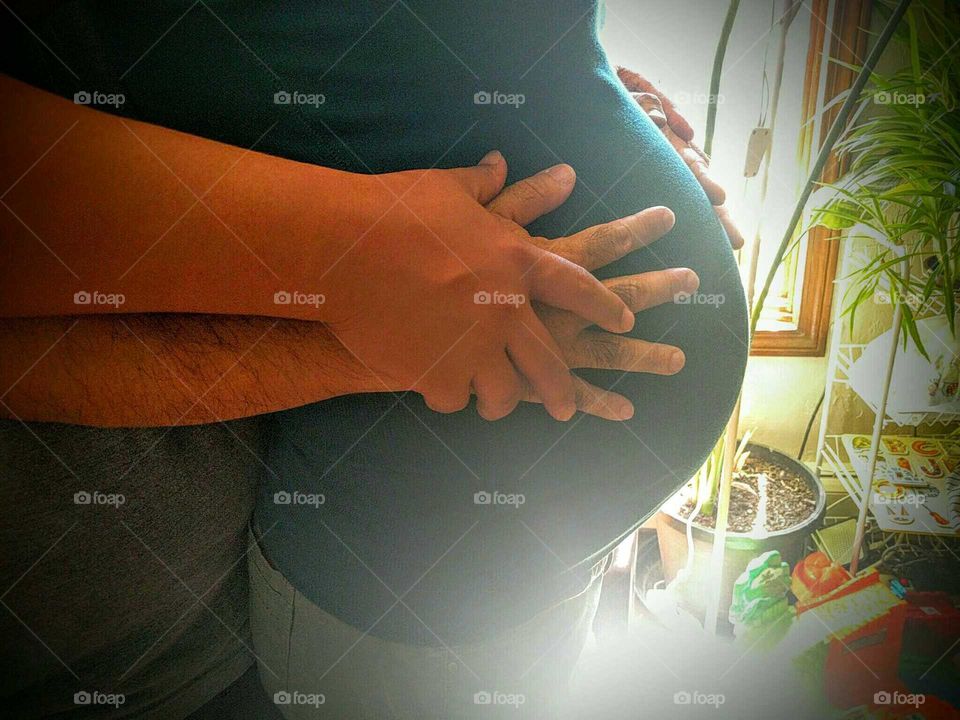 A couple embraces their unborn boy