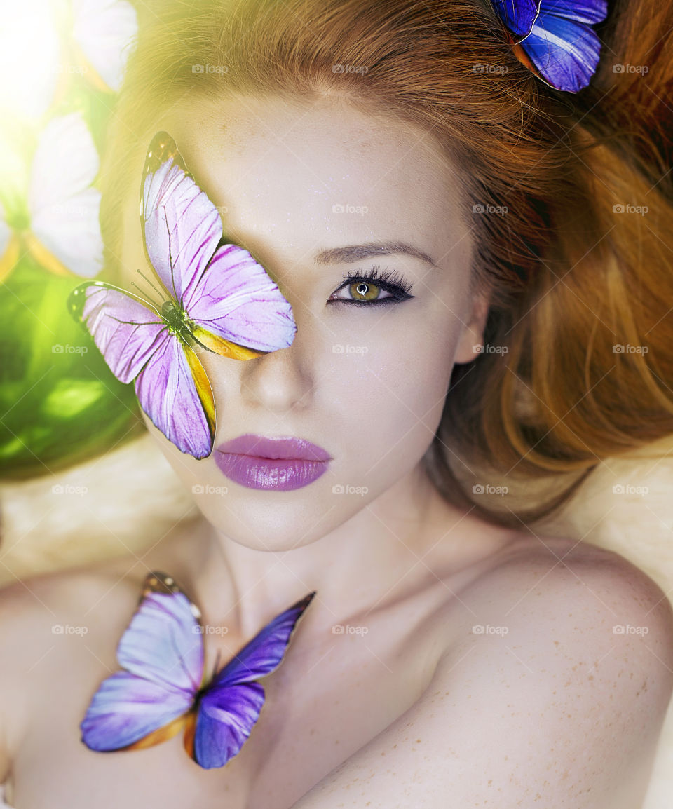 Close-up of butterflies with woman's face