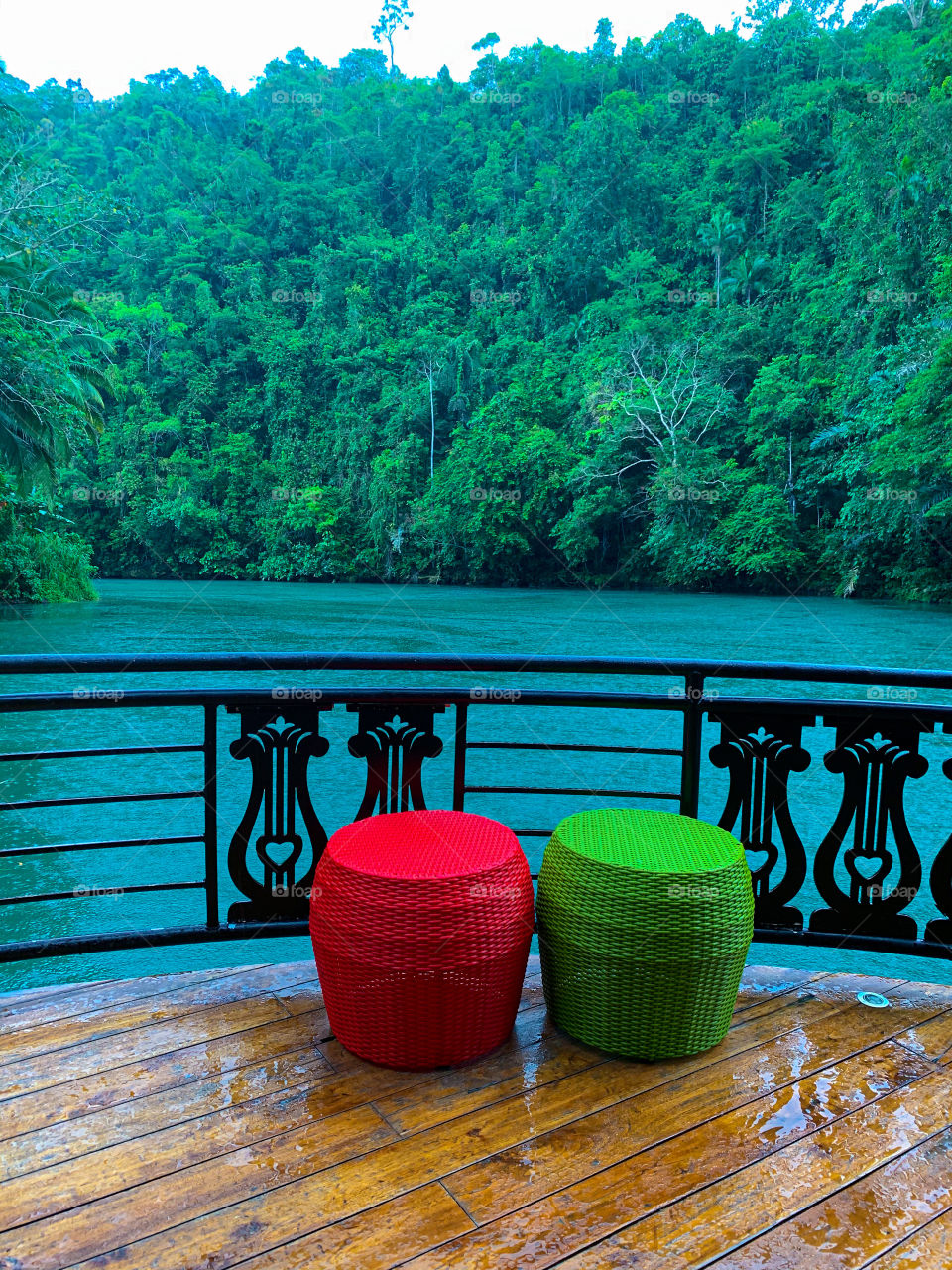 Two wooden chairs color red and green.
